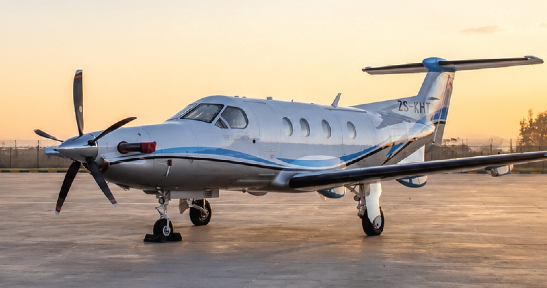 Pilatus PC-12 turboprop on the apron at sunset